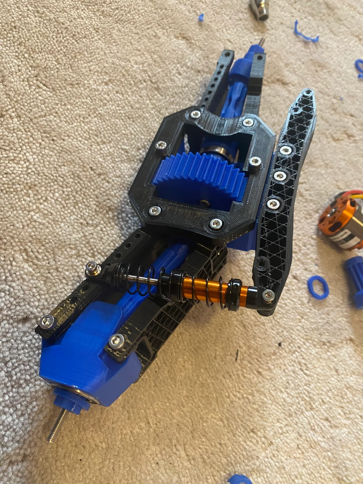 Exposed blue gears in the printed drivetrain assembly.
